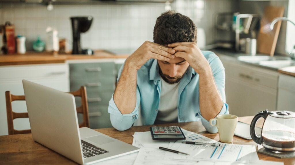 Frustrated man looking at bills