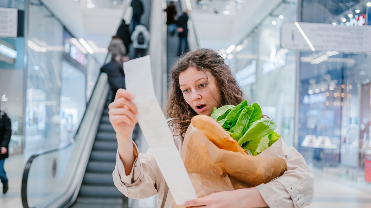 Woman shocked holding groceries