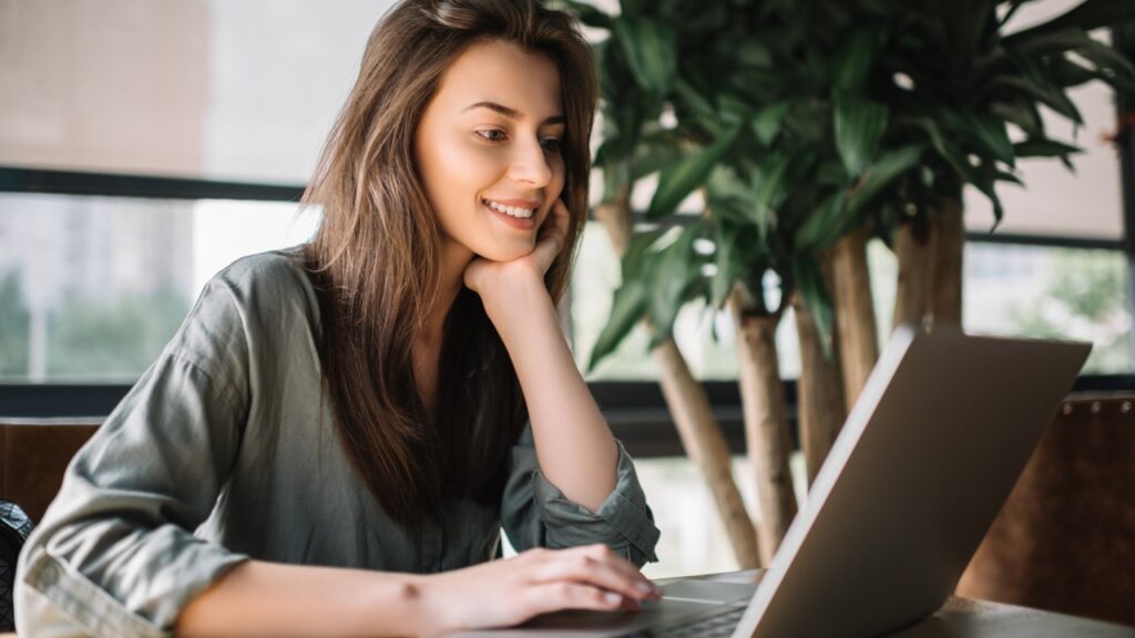 Woman smiling using computer