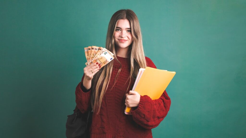 Girl smiling and holding money