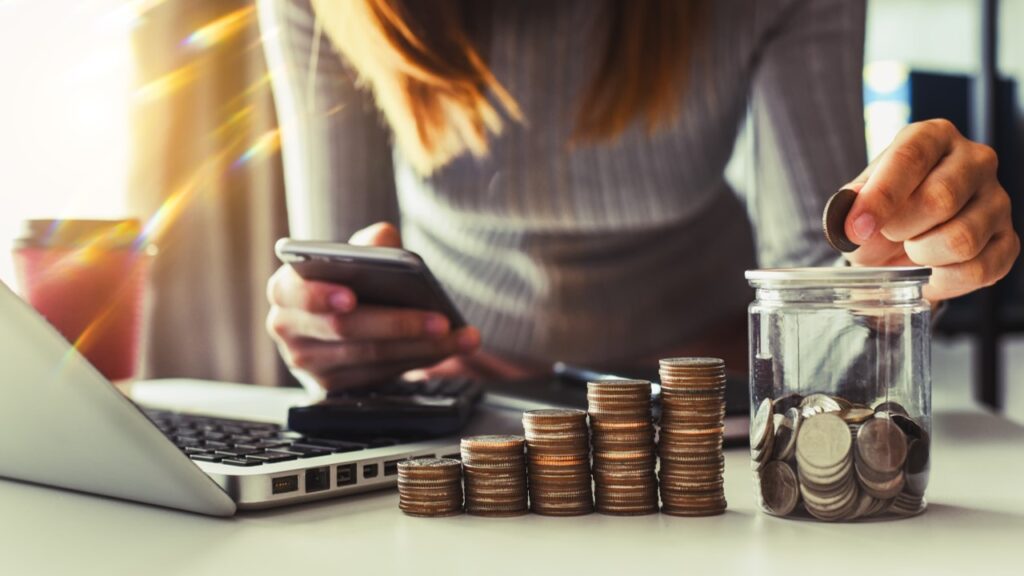 Woman putting coin in pile