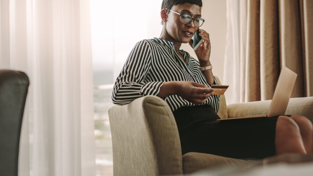 Woman holding card and talking on the phone