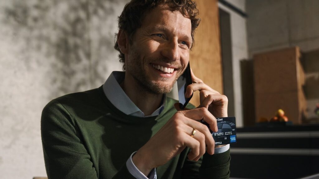 Man smiling and holding the card