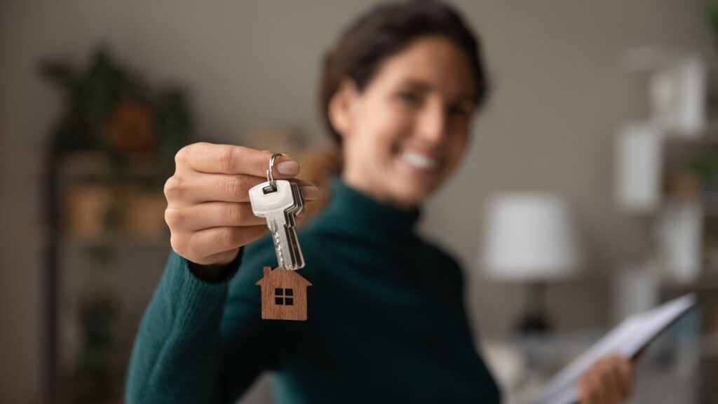 Woman smiling holding house keys