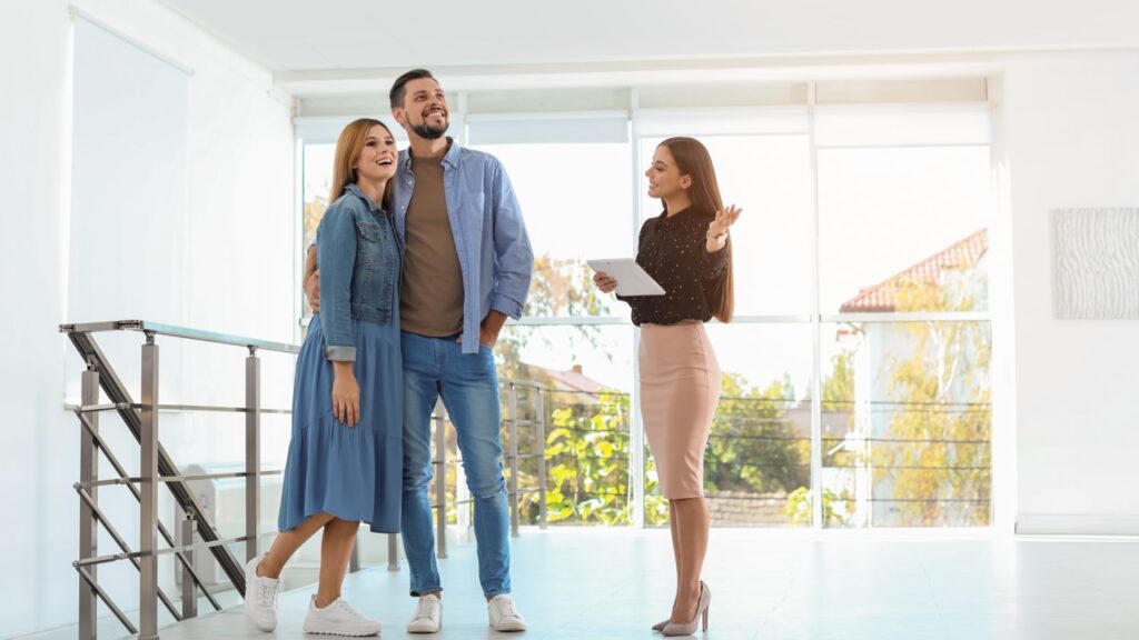 Real estate agent showing house to couple